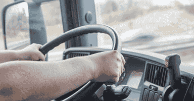 View Out Windshield of a Moving Truck Driver Making a Long Distance Move Down Highway Road.