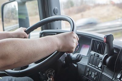 View Out Windshield of a Moving Truck Driver Making a Long Distance Move Down Highway Road.