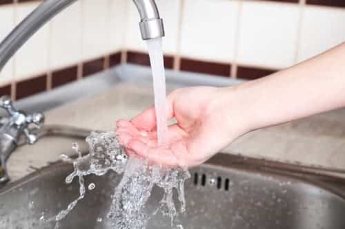 Running Water onto hand over sink. Turned on before the move