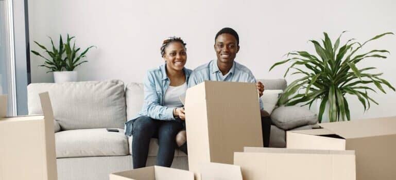 A couple sitting near boxes