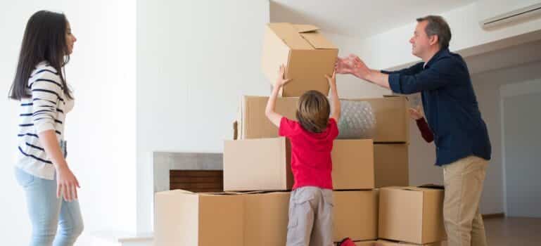 A family unpacking boxes after moving with movers Stamford CT