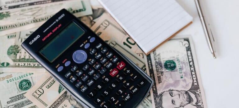 A calculator and paper bills
