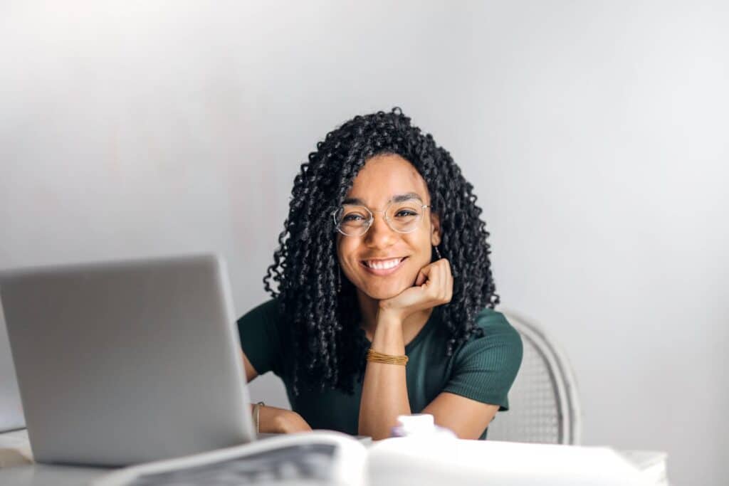 A woman sitting and smiling