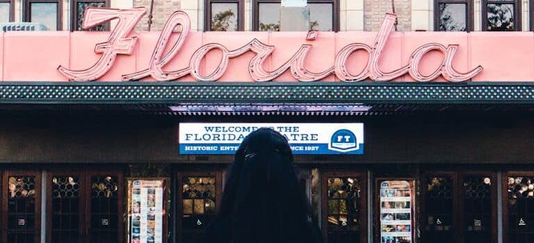 A woman looking at Florida sign
