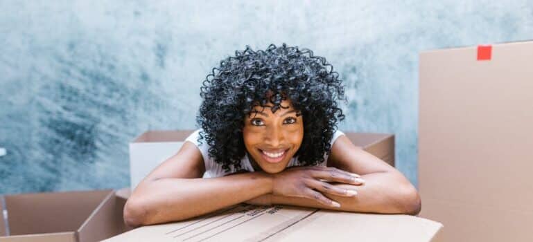 A woman with curly hair smiling after moving with movers New Canaan CT
