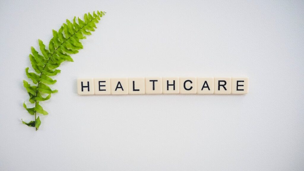 Healthcare text near green fern leaf