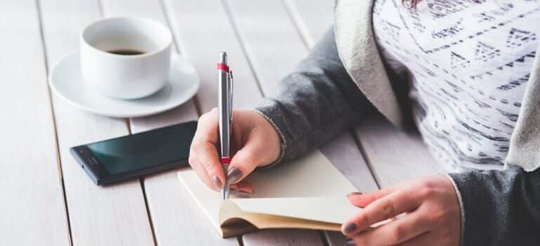 woman writing about how Get Rid of Junk After Moving a Restaurant