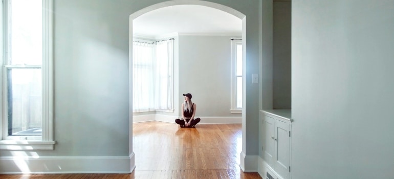 Person sitting in an empty home 