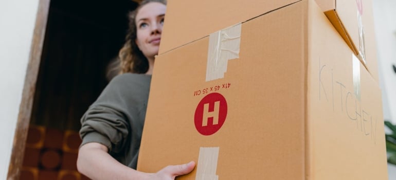Person carrying cardboard boxes