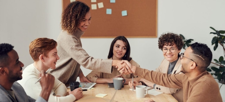 People during an office meeting before moving from Connecticut to Delaware
