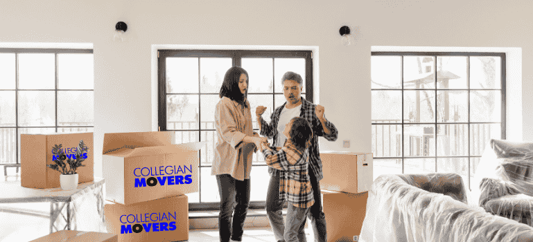 A family celebrating their move among boxes