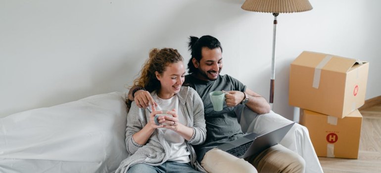 A couple sitting and searching for international movers Connecticut offers