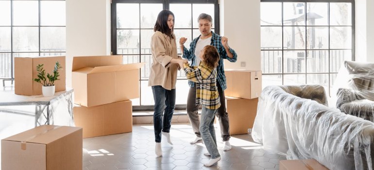 A family having fun in their new house after moving with international movers Connecticut