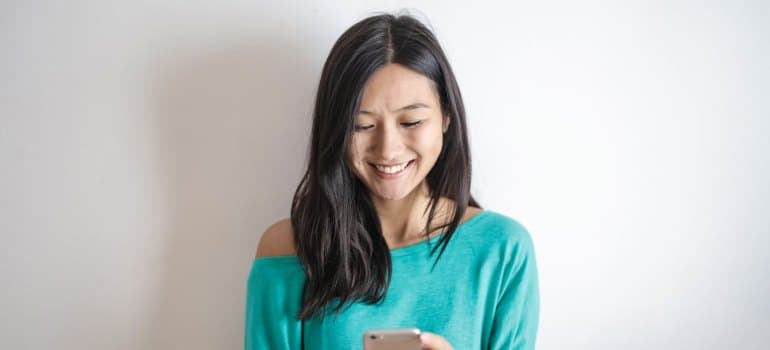 A woman contacting one of the interstate moving companies Connecticut​