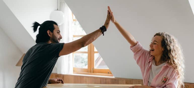 A couple giving high five to each other
