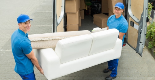 two men moving a couch