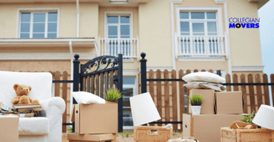 boxes with furniture placed outside a fenced in home ready to be moved
