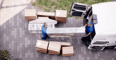 Collegian Movers provides affordable hourly moving help for homeowners and renters who need reliable loading and unloading assistance. Shown here, two uniformed movers carefully load an unmarked van, representing the company’s dependable, local labor-only moving services.