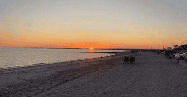Scenic Long Beach Stratford CT sunset with calm waves and horizon view