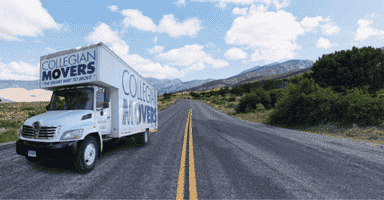 Moving truck transporting a piano on the highway using specialty piano transportation services