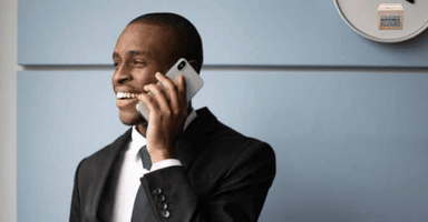 Man in business suit on cell phone, discussing his Hamden Move.